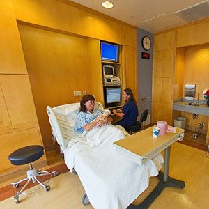 Healthcare professional in a birthing suite with mother and baby