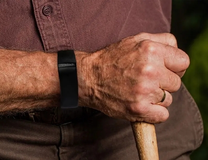 man holding pole with smart watch